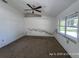 This bedroom has a ceiling fan, carpeted floor, and a window at 6610 Chippendale Rd, Lakeland, FL 33809