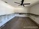 Bedroom with carpet, ceiling fan, and wall damage from moisture at 6610 Chippendale Rd, Lakeland, FL 33809