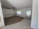 Spacious living room featuring tile entry and plush carpet with natural light at 6610 Chippendale Rd, Lakeland, FL 33809