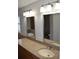 Double vanity bathroom with granite countertops, chrome fixtures, and well-lit mirrors at 676 Jessanda Cir, Lakeland, FL 33813