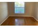 Bright bedroom with wood floors and a window overlooking a green lawn at 676 Jessanda Cir, Lakeland, FL 33813