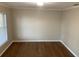 Cozy bedroom with warm wood floors, neutral walls, and a window providing natural light and view at 676 Jessanda Cir, Lakeland, FL 33813