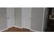 Bedroom view showing closet, doors and glimpse into ensuite bathroom with tub at 676 Jessanda Cir, Lakeland, FL 33813