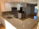 Kitchen featuring stainless steel appliances, white cabinets, a breakfast bar, and hardwood floors at 676 Jessanda Cir, Lakeland, FL 33813