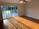 Living room with hardwood floors, sliding glass doors, and a view to the outdoor patio and yard at 676 Jessanda Cir, Lakeland, FL 33813