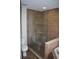 Tiled walk-in shower with glass door and built-in shelves, adjacent to soaking tub at 676 Jessanda Cir, Lakeland, FL 33813