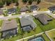 Aerial view of a home with a screened pool, landscaping, and green lawn at 6777 Bentridge Dr, Lakeland, FL 33813