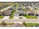Stunning aerial view of the property showcasing lush landscaping and beautiful homes in a desirable neighborhood at 6777 Bentridge Dr, Lakeland, FL 33813
