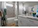 Well-lit bathroom with a marble vanity, a shower/tub combo, and a gray accent wall at 6777 Bentridge Dr, Lakeland, FL 33813