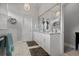 Bright bathroom with marble floors, granite vanity, and modern chandelier, creating a spa-like atmosphere at 6777 Bentridge Dr, Lakeland, FL 33813