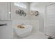 Modern bathroom featuring a freestanding tub with a mounted faucet, and a marble tiled floor at 6777 Bentridge Dr, Lakeland, FL 33813