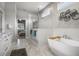 Luxurious bathroom boasting a freestanding tub, glass shower, and marble tile throughout at 6777 Bentridge Dr, Lakeland, FL 33813