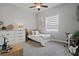 Bright bedroom with ceiling fan, and a stylish desk and guitar, ideal for music and studies at 6777 Bentridge Dr, Lakeland, FL 33813