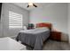 Cozy bedroom featuring a full sized bed, ceiling fan, desk, and horizontal blinds at 6777 Bentridge Dr, Lakeland, FL 33813