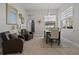 An open dining area with neutral tones, natural light, and contemporary furnishings at 6777 Bentridge Dr, Lakeland, FL 33813