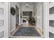 Bright foyer with wood-look tile flooring, stylish decor, and a view to the living area at 6777 Bentridge Dr, Lakeland, FL 33813