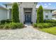 Welcoming entrance with a stylish blue door, stone accents, and professionally landscaped plantings at 6777 Bentridge Dr, Lakeland, FL 33813