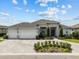 Stunning single-story home featuring a three-car garage and a beautifully landscaped front yard at 6777 Bentridge Dr, Lakeland, FL 33813