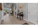 Elegant hallway with wood-look tile flooring and views of the living room and pool at 6777 Bentridge Dr, Lakeland, FL 33813