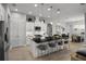 Modern kitchen with large island, barstool seating, and stainless appliances, open to the living area at 6777 Bentridge Dr, Lakeland, FL 33813
