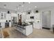 Stylish kitchen with a large island, barstool seating, stainless appliances, and white cabinets at 6777 Bentridge Dr, Lakeland, FL 33813