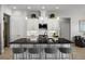 Modern kitchen features a spacious island, bar seating, stainless appliances, and white cabinetry at 6777 Bentridge Dr, Lakeland, FL 33813