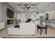 Open-concept living room with stone fireplace, coffered ceiling, and stylish furniture at 6777 Bentridge Dr, Lakeland, FL 33813