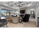 Comfortable living room featuring a stone fireplace, coffered ceilings, and serene pool views at 6777 Bentridge Dr, Lakeland, FL 33813