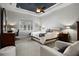 Spacious main bedroom with a tray ceiling, carpet floors, and a large window at 6777 Bentridge Dr, Lakeland, FL 33813