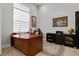 Spacious home office with natural light, a large desk, and custom cabinetry at 6777 Bentridge Dr, Lakeland, FL 33813