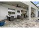 Covered patio with outdoor seating and dining area provides an ideal space for entertaining and relaxation at 6777 Bentridge Dr, Lakeland, FL 33813