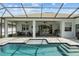 Relaxing covered lanai featuring a swimming pool, spa, ceiling fans and outdoor seating at 6777 Bentridge Dr, Lakeland, FL 33813