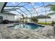 Screened pool area with gray pavers and a small raised blue-tiled spa at 6777 Bentridge Dr, Lakeland, FL 33813