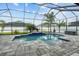 Screened in pool featuring pavers, tropical landscaping, and an attached spa at 6777 Bentridge Dr, Lakeland, FL 33813