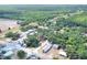 Expansive aerial shot showcases this home's location surrounded by lush greenery and nearby community amenities at 6949 2Nd St, Mulberry, FL 33860