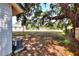 Spacious backyard featuring a large oak tree and partial view of the home at 6949 2Nd St, Mulberry, FL 33860