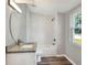 Well-lit renovated bathroom showcasing modern fixtures, including a sleek vanity and tiled shower area at 6949 2Nd St, Mulberry, FL 33860