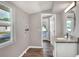 Modern bathroom with gray walls, granite vanity, new mirror, and tiled shower and tub at 6949 2Nd St, Mulberry, FL 33860