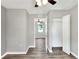 Bedroom with hardwood floors, closet, and neutral paint; adjoining space visible at 6949 2Nd St, Mulberry, FL 33860