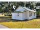 Exterior view of the house with a green metal roof at 6949 2Nd St, Mulberry, FL 33860