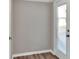 Hallway featuring modern gray walls and a white door leading to the outside at 6949 2Nd St, Mulberry, FL 33860
