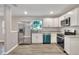 Modern kitchen features stainless steel appliances, white cabinets, granite countertops, and wood-look floors at 6949 2Nd St, Mulberry, FL 33860