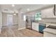 Open concept kitchen view showcasing stainless steel appliances, granite countertops and wood-look flooring at 6949 2Nd St, Mulberry, FL 33860