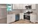 Well-equipped kitchen with stainless steel appliances, modern cabinets, and ample counter space with wood-look flooring at 6949 2Nd St, Mulberry, FL 33860