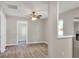 Open concept living room featuring light gray walls, a modern ceiling fan, and attractive wood-look flooring at 6949 2Nd St, Mulberry, FL 33860