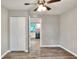 Inviting living room with neutral walls, closet and wood-look floors, leading to a bright, modern kitchen at 6949 2Nd St, Mulberry, FL 33860