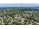 Expansive aerial view of a residential neighborhood with lush green trees and glimpses of a nearby lake at 707 Laurel Pointe Ct, Lakeland, FL 33813