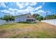 Exterior angle of home showing upper wooden deck, screened in patio, and large, mostly fenced backyard at 707 Laurel Pointe Ct, Lakeland, FL 33813