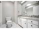 Bathroom featuring updated vanity and granite countertops, a skylight, and modern fixtures at 707 Laurel Pointe Ct, Lakeland, FL 33813