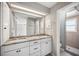Bathroom featuring double sink vanity with granite countertop, complemented by white cabinets and neutral paint at 707 Laurel Pointe Ct, Lakeland, FL 33813